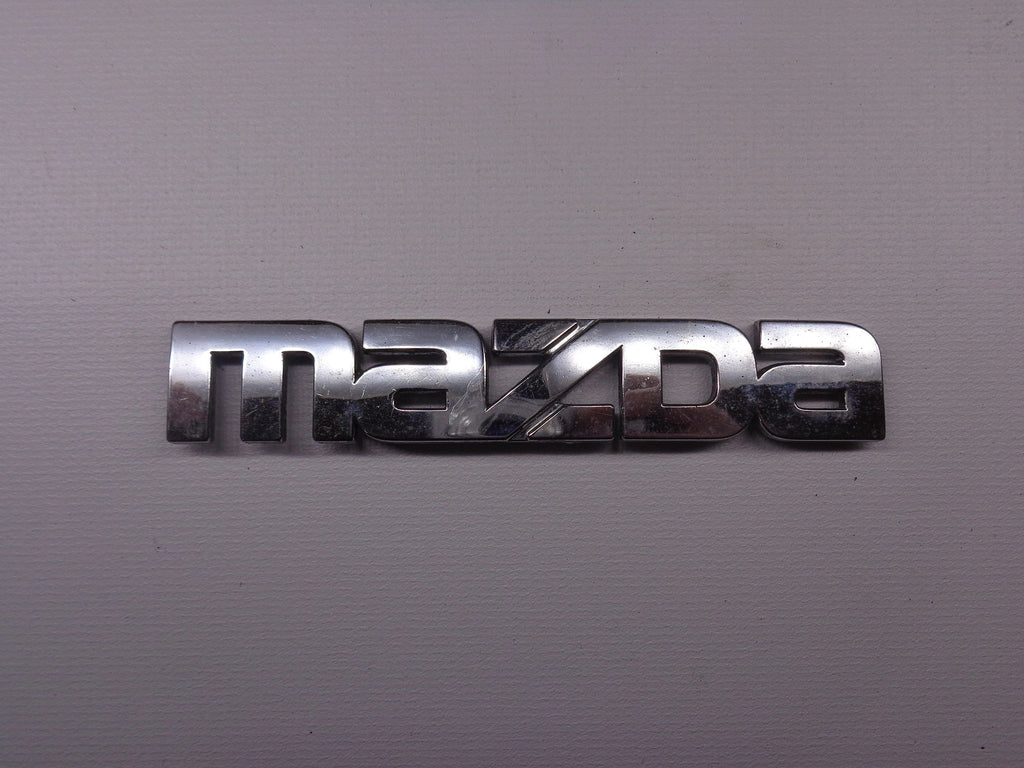 Mazda Emblem for Passenger Side Rear Finish Panel Factory Used 1990-1997 NA Mazda Miata