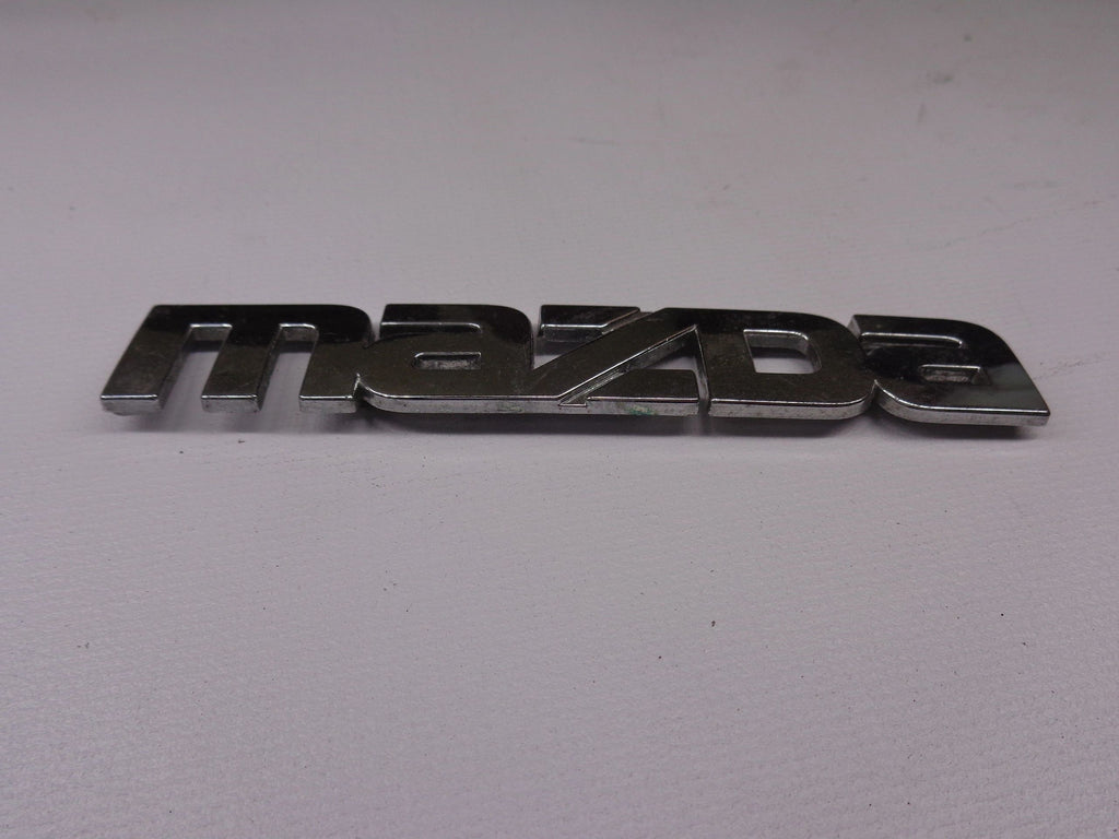 Mazda Emblem for Passenger Side Rear Finish Panel Factory Used 1990-1997 NA Mazda Miata